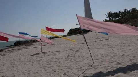 Flags on the Beach with Lighthouse Background Video stock 83966528