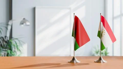 FLAGS OF  BELARUS AND TAJIKISTAN  ON TABLE Stock Photos