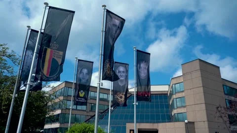 Flags with Belgian soccer logo and Eden Hazard at the headquarters of the Stock Footage 154940796