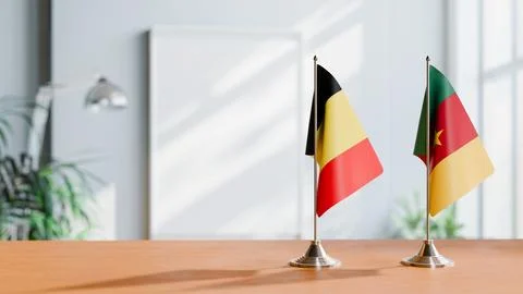 FLAGS OF  BELGIUM AND CAMEROON  ON TABLE Stock Photos