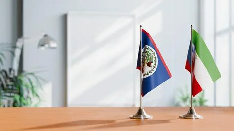 FLAGS OF BELIZE AND EQUATORIAL GUINEA ON TABLE Stock Photos