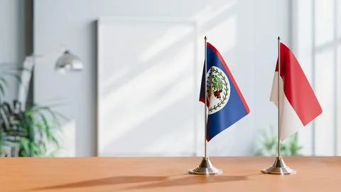 FLAGS OF BELIZE AND INDONESIA ON TABLE Stock Photos