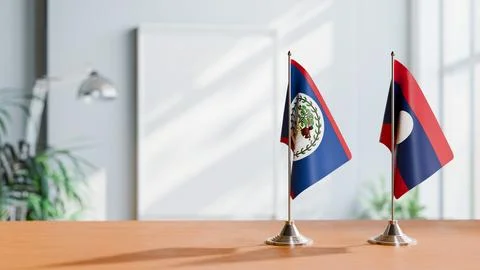 FLAGS OF BELIZE AND LAOS ON TABLE Stock Photos