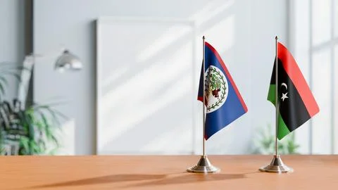 FLAGS OF BELIZE AND LIBYA ON TABLE Stock Photos