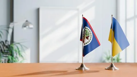 FLAGS OF BELIZE AND UKRAINE ON TABLE Stock Photos