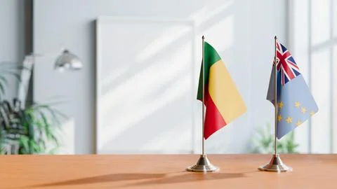 FLAGS OF BENIN AND TUVALU ON TABLE Stock Photos