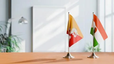 FLAGS OF BHUTAN AND NIGER ON TABLE Stock Photos