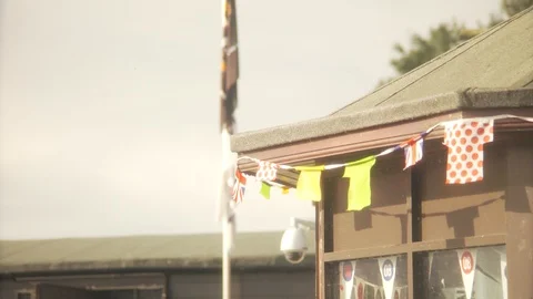 Flags blowing in the wind at a kiosk Stock Footage 113336975