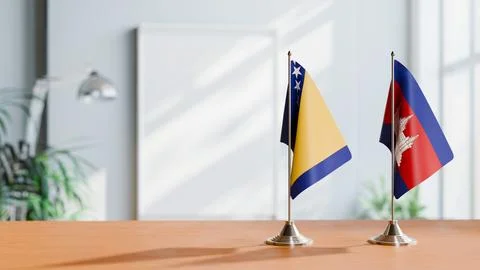 FLAGS OF BOSNIA AND CAMBODIA ON TABLE Stock Photos