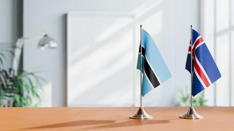 FLAGS OF BOTSWANA AND ICELAND ON TABLE Stock Photos