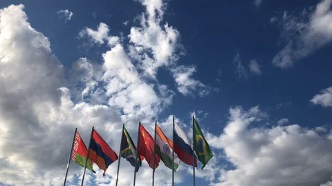 Flags Of BRICS Countries Waving in the Wind Against Blue Sky Stock Footage 109461261