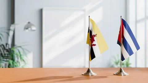 FLAGS OF BRUNEI AND CUBA ON TABLE Stock Photos