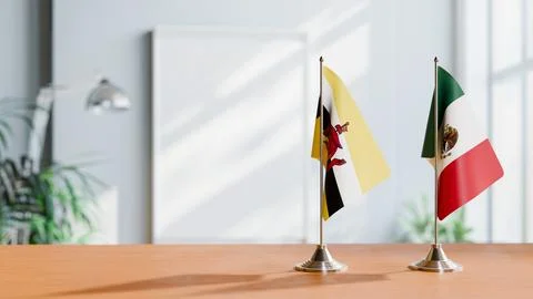 FLAGS OF BRUNEI AND MEXICO ON TABLE Stock Photos