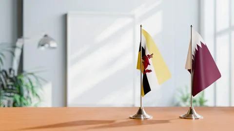 FLAGS OF BRUNEI AND QATAR ON TABLE Stock Photos