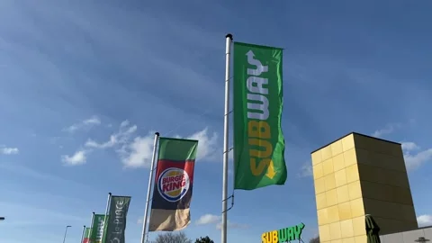 The flags of the Burger King and Subway flutter in the wind Stock Footage 149372332