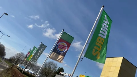 The flags of the Burger King and Subway flutter in the wind Stock Footage 149372354