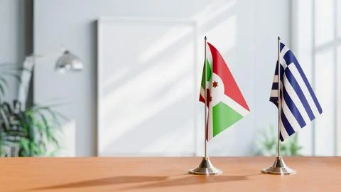 FLAGS OF BURUNDI AND GREECE ON TABLE Stock Photos