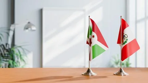 FLAGS OF BURUNDI AND PERU ON TABLE Stock Photos