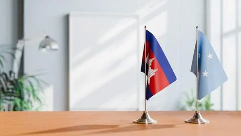 FLAGS OF CAMBODIA AND MICRONESIA ON TABLE Stock Photos