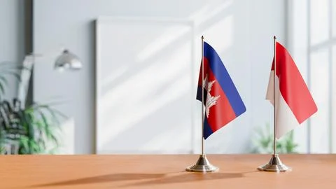 FLAGS OF CAMBODIA AND MONACO ON TABLE Stock Photos