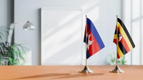 FLAGS OF CAMBODIA AND UGANDA ON TABLE Stock Photos