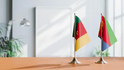 FLAGS OF CAMEROON AND ERITREA ON TABLE Stock Photos
