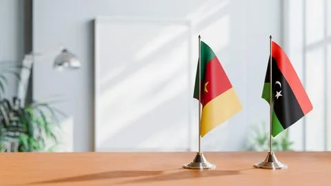 FLAGS OF CAMEROON AND LIBYA ON TABLE Stock Photos