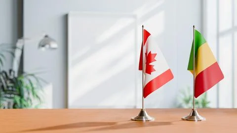 FLAGS OF CANADA AND MALI ON TABLE Stock Photos