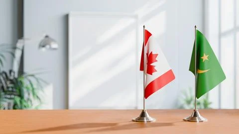 FLAGS OF CANADA AND MAURITANIA ON TABLE Stock Photos