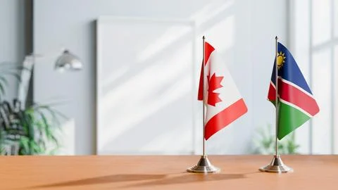 FLAGS OF CANADA AND NAMIBIA ON TABLE Stock Photos