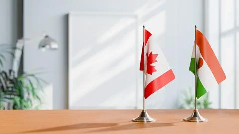 FLAGS OF CANADA AND NIGER ON TABLE Stock Photos