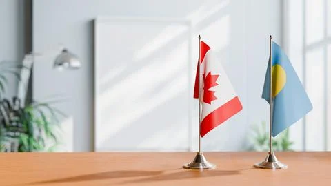 FLAGS OF CANADA AND PALAU ON TABLE Stock Photos