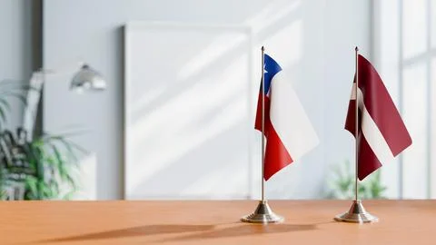 FLAGS OF CHILE AND LATVIA ON TABLE Stock Photos