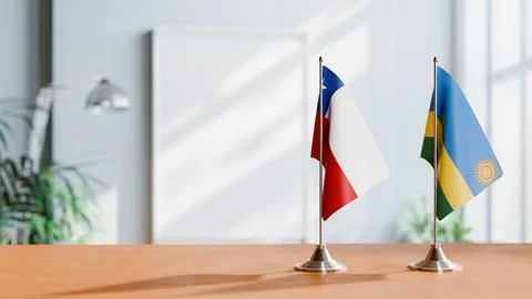 FLAGS OF CHILE AND RWANDA ON TABLE Stock Photos