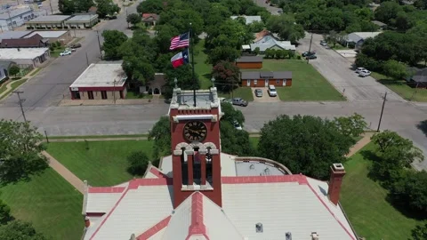 Flags, Clocktower, and Courthouse, Giddings, Texas, USA Stock Footage 142106989