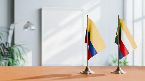 FLAGS OF COLOMBIA AND COMOROS ON TABLE Stock Photos