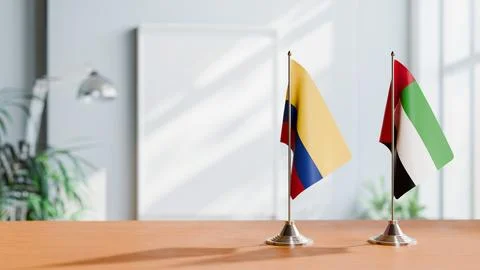FLAGS OF COLOMBIA AND UAE ON TABLE Stock Photos