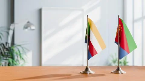 FLAGS OF COMOROS AND ERITREA ON TABLE Stock Photos