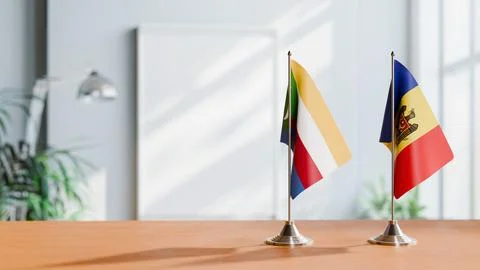 FLAGS OF COMOROS AND MOLDOVA ON TABLE Stock Photos