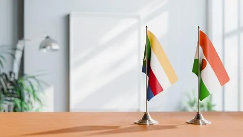 FLAGS OF COMOROS AND NIGER ON TABLE Stock Photos
