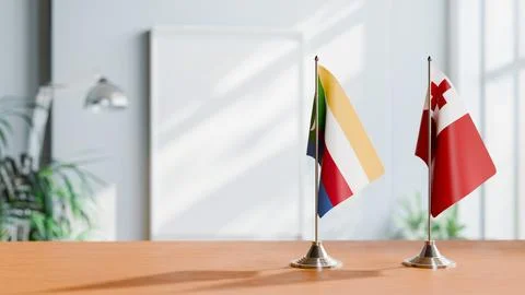 FLAGS OF COMOROS AND TONGA ON TABLE Stock Photos