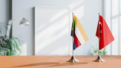 FLAGS OF COMOROS AND TURKEY ON TABLE Stock Photos