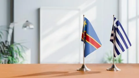 FLAGS OF CONGO DEMOCRATIC REPUBLIC AND GREECE ON TABLE Stock Photos