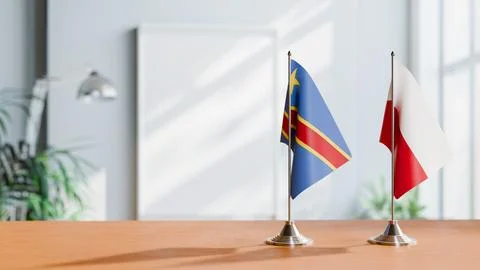 FLAGS OF CONGO DEMOCRATIC REPUBLIC AND POLAND ON TABLE Stock Photos