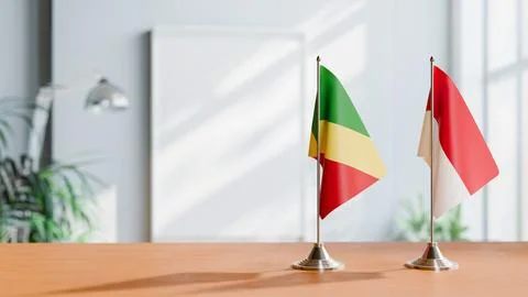FLAGS OF CONGO R AND MONACO ON TABLE Stock Photos