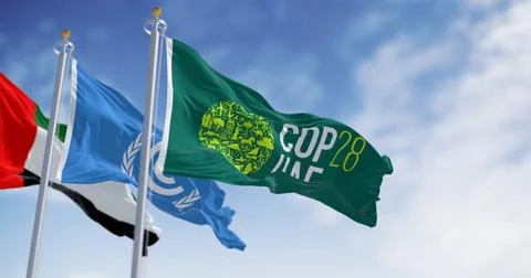 Flags of COP28, UNFCCC and UAE waving on a clear day. Stock Illustration