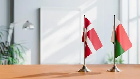 FLAGS OF DENMARK AND MADAGASCAR ON TABLE Stock Photos