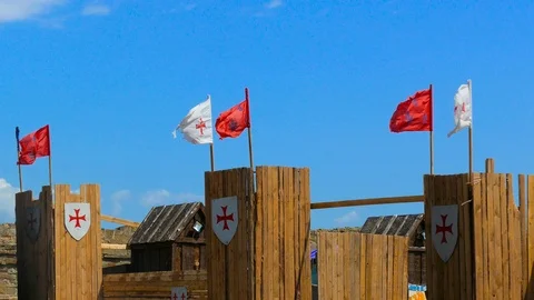 Flags develop over walls of wooden fort Stock-Footage 123584628