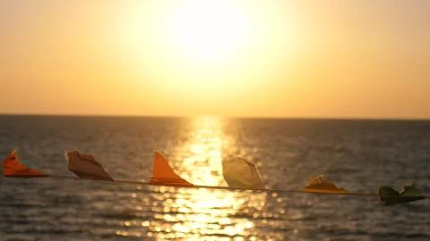 Flags develop in the wind against the background of the sea on the beach during 스톡 사진