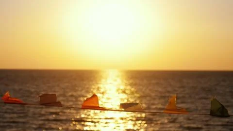Flags develop in the wind against the background of the sea on the beach during 스톡 사진
